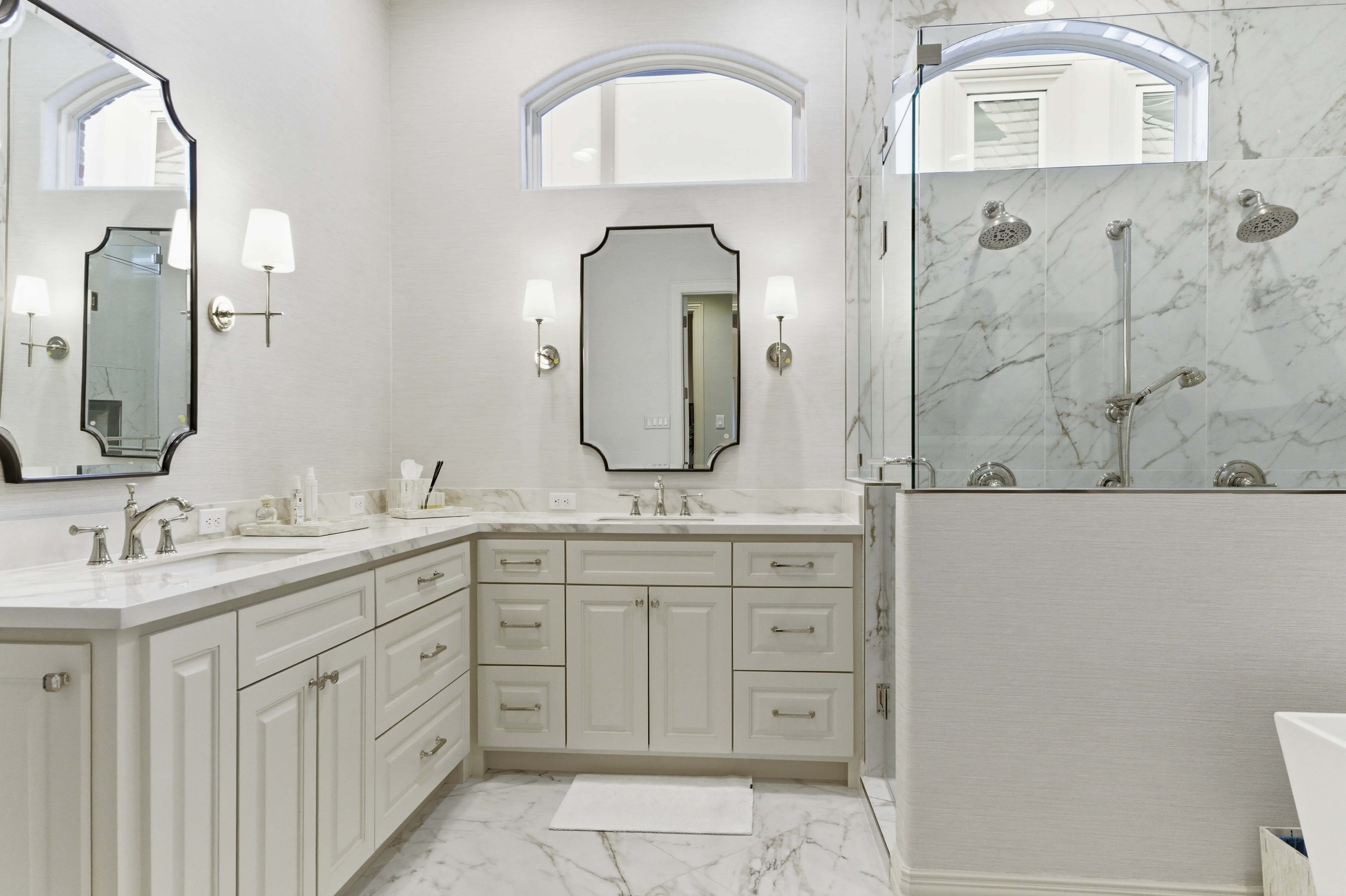 Spa-inspired primary bathroom with dual vanities and porcelain finishes